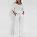 Linen two piece set detail shot showing breathable fabric, loose fit short sleeve top and wide leg pants. - S / Top And Bottom / White