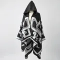 Detailed view of black and grey patterned hooded knit poncho cloak for travel - One Size / Black