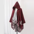 Elegant wine red hooded knitted poncho with butterfly floral pattern on mannequin - Robe / Burgundy