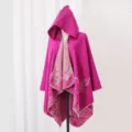 Detailed view of fuchsia hooded knitted cloak featuring elegant butterfly and floral patterns - Robe / Rose Pink