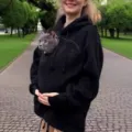 Black fleece pet pouch hoodie detail, featuring a cozy front pocket for small cats and dogs, soft warm fabric. - 4XL / Black