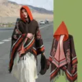 Ethno-Kapuzenponcho für Damen mit dekorativen Mustern und stilvollen Fransen am Saum. - Kaffee und Orange