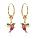 Close-up view of gold hummingbird hoop earrings with green and magenta stones - Hummingbird Hoop Earrings / Red
