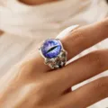 Close-up of vintage silver monster claw ring with purple dragon eye - Open Adjustable / Purple