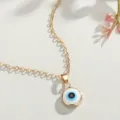 Detailed view of the gold-plated Turkish evil eye pendant with blue enamel inlay - Gold Round Plate Blue Eye Style (NC21Y0416-1)