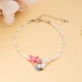 Detailed macro view of white beaded bracelet featuring starfish and shell charms - White Seed Beads with Pink Starfish Shell Pendant (BR23Y0284-2)