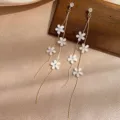 Close-up of elegant long tassel earrings with delicate white flowers and studs - White Five-Petal Flower Tassel (ER21Y0168)