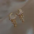 Close-up of elegant gold moon and star tassel earrings with sparkling rhinestones - Gold Moon Star Tassel (ER20Y1125)