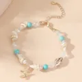 Detailed view of Bohemian shell bracelet with starfish charm and turquoise beads on warm background. - Natural Shell Turquoise Crystal Beads Gold Starfish (BR23Y0285-1)