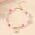 Detail view of a Bohemian shell bracelet with pink beads and a gold starfish charm for summer. - Natural Shell Pink Beads with Gold Starfish (BR23Y0285-2)