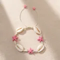 Macro detailed view of bohemian woven cord bracelet with cowrie shells and pink starfish - Off-white Braided Rope with Shell Starfish (BR23Y0414-1)