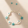 Close-up of bohemian shell bracelet with starfish and evil eye beads on beach-like texture. - Off-white Braided Rope with Evil Eye Shell (BR23Y0414-2)