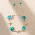 Detail view of Bohemian seashell bracelet with starfish and sea turtle print on cream cord. - Off-white Braided Rope with Turtle Shell Starfish (BR23Y0414-3)