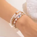 Stapelbares Perlen- und Goldperlen-Armbandset mit MAMA-Buchstaben und blauem Auge - Perle und Kreuz Stil (BR25Y0043-3)