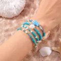 Set de 4 pulseras boho con cuentas turquesas y dijes de concha y pez de cerámica - Estilo azul, blanco y dorado