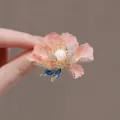 Close-up of elegant pink peony flower brooch with center pearl and blue leaves - Pink Peony Flower