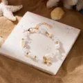 Bohemian style beach bracelet with shells, crushed stone, and golden starfish charm. - Bracelet / Clear