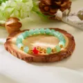 Green beaded zodiac bracelet with golden snake charm and red accent bead for women - Light Green With Red Bead
