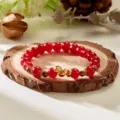 Elegant red beaded bracelet featuring a golden snake charm for the 2025 Year of the Snake - Red