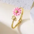 Gold-finish bangle with pink daisy and bee detail for a fresh, elegant look. - Bangle / Pink