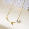 Exquisite golden necklace featuring a white enamel daisy flower and leaf pendant - Necklace / White