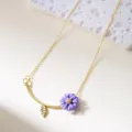 Elegant gold necklace with purple daisy pendant and leaf charm details - Necklace / Purple