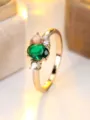 Detailed close-up shot of a golden ring featuring a green oval stone and opal accent - Size 6 / Gold (Green Stone)