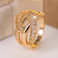 Close-up of elegant gold-toned hollow braided cross-shaped ring for women - Size 6 / Hollow Woven Criss Cross Style (RR018) / Gold