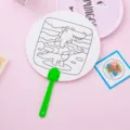 Creative DIY coloring fan for kids featuring a cute cartoon crocodile surfing design - Crocodile