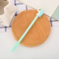 Cute mint green cartoon unicorn gel pen for students placed on a wooden coaster. - 0.5mm / Green