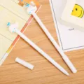 Set of two cute whale-shaped gel pens for students displayed on a wooden desk surface - White