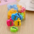 Set of colorful apple-shaped manual pencil sharpeners inside a clear plastic storage jar - Apple-L