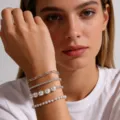Layered bracelet set featuring paperclip chains, pearl beads, and silver-tone metal links. - Four-Piece Set / Silver