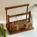Detail of walnut jewelry organizer with tiered hooks and watch display stand - Walnut