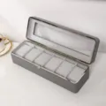 Vue détaillée d'un coffret à montres gris 6 emplacements avec cadre métallique chic - 6 Emplacements / Gris