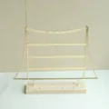 Detalle del soporte para pendientes de hierro dorado de 4 niveles con base de madera - Dorado