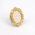 Detail view of a vintage gold resin jewelry display stand for ring organization - Oval Ring Velvet Style / 12 x 10cm / Beige