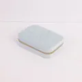 Detailed view of light blue quilted velvet travel jewelry box with golden zipper - 16.5x11.5x5cm / Light Blue