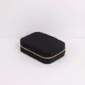 Detailed close-up view of portable black quilted jewelry box with gold zipper for travel - 16.5x11.5x5cm / Black