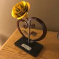Metal yellow rose sculpture with heart-shaped stand, romantic gift for Valentine's Day decor. - Yellow
