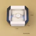 Boîte à montres octogonale en plastique de qualité avec couvercle transparent et coussin - Noir et Blanc