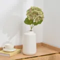 Artificial hydrangea flower arrangement in white ceramic vase for home wedding decor detail - Green