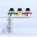 Christmas wooden door corner decoration with cute snowmen and snowflakes design for holiday. - Three Snowmen
