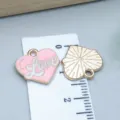 Macro detail of pink enamel heart charm with Love script and golden sunburst back - Love Heart Letter (25162) / 1 Piece (14x15x1mm) / Pink