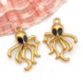 Detailed view of gold plated stainless steel octopus charms featuring black enamel eyes - Stainless Steel Enamel Black Octopus Style (T1563) / 1 Piece (18*24*5mm) / Gold with Black