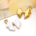Close-up detail of white enamel and gold stainless steel bow charms for DIY jewelry making. - 蝴蝶结吊坠(T1514) / 1个装 (12*13*3mm) / White