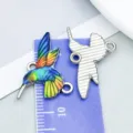Colorful enamel hummingbird charms for DIY jewelry making, front and back views on ruler - Colorful Drip Oil Hummingbird (27589)
