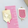 Detailed view of pink enamel medical charms and gold pendants for DIY jewelry making - Infusion Bag (23048) / 1 Piece/Pack (28*15mm) / Pink