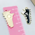 Sporty sneaker charm in black enamel with gold finish and iconic three stripes - Three Stripes Style / 1 Piece (14*26mm) / Black Sneakers