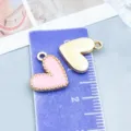 Detail view of pink enamel and gold-toned heart charms with purple ruler for scale - Enamel Heart (14985) / 1 Piece (13*13mm) / Pink